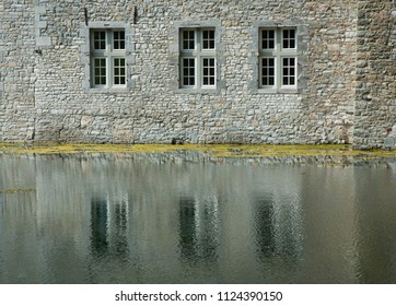 Reflection of wall with windows in water Belgium Gardens of Annevoie
