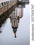 Reflection in the water of a modern temple, built in the 21st century in honor of the Cathedral of St. John the Baptist on the embankment of the city of Dnieper River in Ukraine.