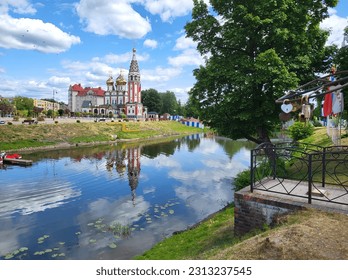 Reflection in the water of an Orthodox church on a summer day. City of Gusev, Kalingrad region.