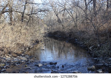 Reflection Of Water In Stream Crossing The Gary L. Haller Trail In Johnson County, Kansas