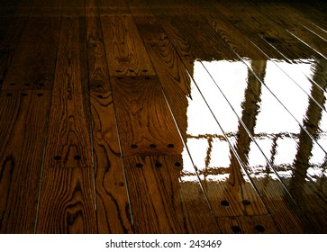 reflection of a window on a hardwood floor