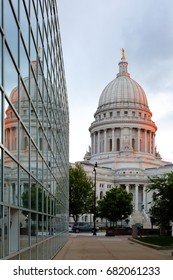 The Reflection Of Wisconsin State Capital On A Glass Building At Sunset Madison, Wisconsin USA. The State Capitol Houses Both Chambers Of The Wisconsin Legislature Along With Wisconsin Supreme Court.