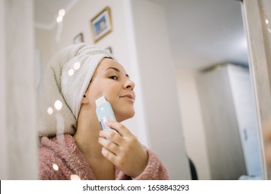 Reflection Of A Woman Exfoliating Her Face With Pore Cleaner