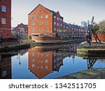 Reflections in the Ashton Canal from the new housing development