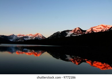 Reflections of a high mountain lake in the spring