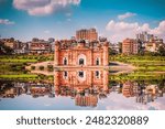 Reflections of the Historic Lalbagh Fort in Dhaka, Bangladesh, Mirrored Against a Clear Blue Sky and Urban Backdrop