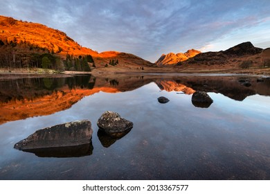 Reflections In Lake At Sunrise On A Winter Morning At Blea Tarn In The Lake District. Scenic Landscapes Of Rural Britain. Nature Backgrounds.
