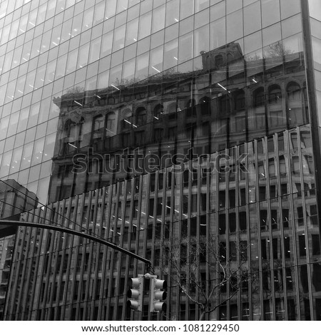 Reflections of an old building on a new building. IBM building in Astor place nyc.