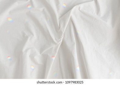 Reflections Of Sunlight Shining Through Prism On White Clean Fabric