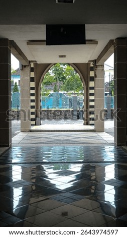 “Geometric Reflections Through an Arched Hallway”
A symmetrical view through a modern archway framed with geometric tiles and reflective flooring. The composition highlights architectural beauty, natu