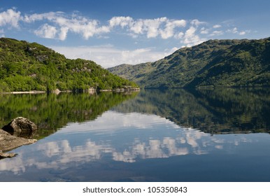 Reflections Of Trees And Clouds On Loch Lomond, Scotland, United Kingdom