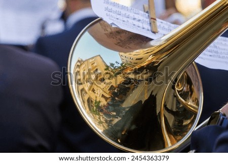 Reflections in the trombone bell of the adjacent buildings during the Alcoy festivities, Spain