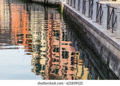 Reflections In The Water Of A Canal In Venice

