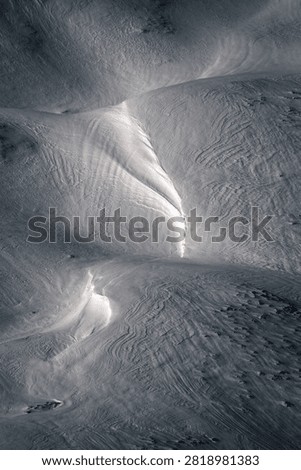Reflections of winter light on the wind paths in the snow in the Ancares mountains Cervantes Lugo Galicia