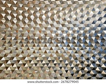 Reflective Geometric Triangle Pattern Wall Texture or Modern Metallic Triangular Facade Background.