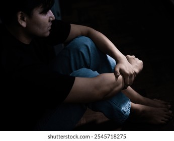 Reflective moment of a young man in contemplation intimate indoor space portrait photography low light environment side view emotional insight - Powered by Shutterstock