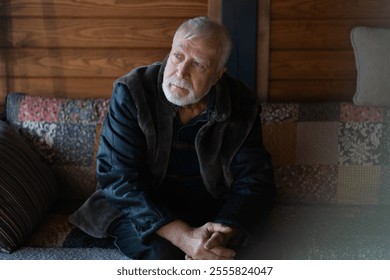 Reflective moments of an elder man in a cozy wooden cabin during a quiet afternoon - Powered by Shutterstock