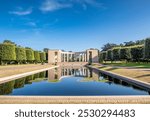 Reflective pond at Normandy American Cemetery and Memorial, honoring fallen WWII soldiers with a peaceful monument set against serene landscapes in Colleville-sur-Mer, France.