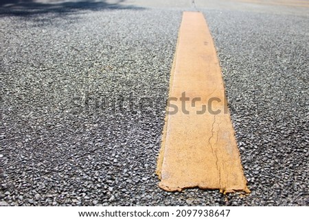 Reflective yellow traffic lines on the road surface