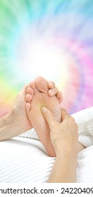 Reflexology Working The Solar Plexus  -  Reflexologist Holding A Client's Foot While Applying Pressure To The Solar Plexus Area On A Rainbow Colored Spiraling Energy Formation Background