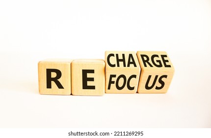 Refocus And Recharge Symbol. Businessman Turned Cubes And Changed The Word 'refocus' To 'recharge'. Beautiful White Table, White Background. Business Refocus And Recharge Concept. Copy Space.