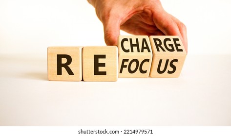 Refocus And Recharge Symbol. Businessman Turns Cubes And Changes The Word 'refocus' To 'recharge'. Beautiful White Table, White Background. Business Refocus And Recharge Concept. Copy Space.