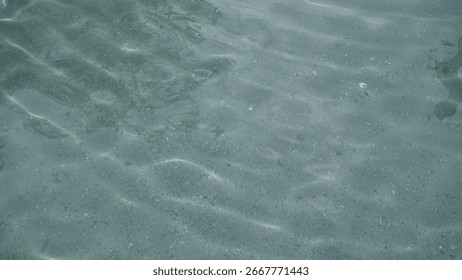 Refraction of light from the sun into a pool of clear spring water