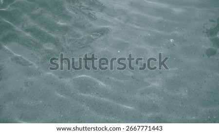 Refraction of light from the sun into a pool of clear spring water