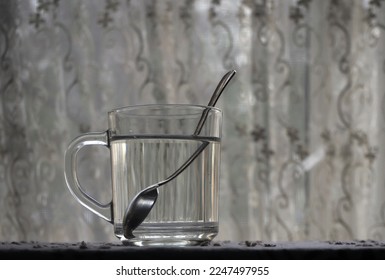 Refraction of the light. Tea spoon inside a glass of water, light refraction.       - Shutterstock ID 2247497955
