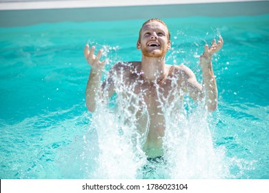 Refresh Yourself. Young Cheerful Bearded Man In Pool Water Splashing Water Looking Up