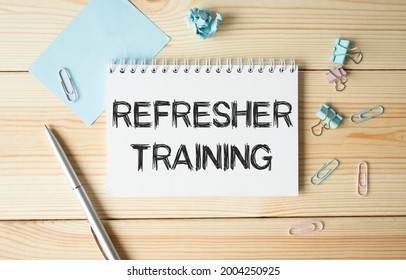 Refresher Training text on paper on wooden background. - Shutterstock ID 2004250925