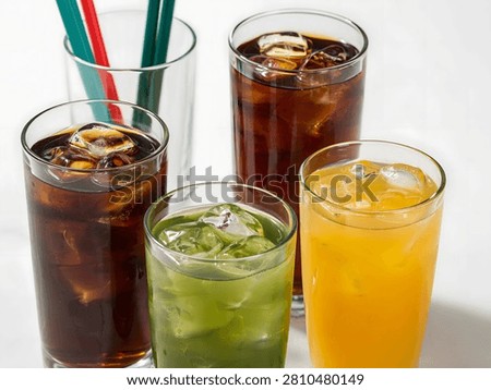 A refreshing assortment of cold beverages with ice is ready to quench your thirst on a warm day