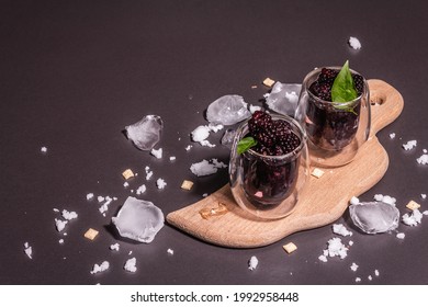 Refreshing Blackberry Fruit Drink. Cold Summer Berry Cocktail, Modern Hard Light, Dark Shadow. Black Stone Concrete Background, Copy Space