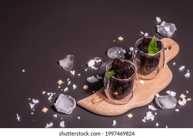 Refreshing Blackberry Fruit Drink. Cold Summer Berry Cocktail, Modern Hard Light, Dark Shadow. Black Stone Concrete Background, Copy Space