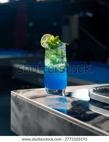 Refreshing Blue Mojito Mocktail with Lime, Mint, and Ice on a Marble Bar Counter