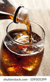 Refreshing Brown Soda With Ice On A Background