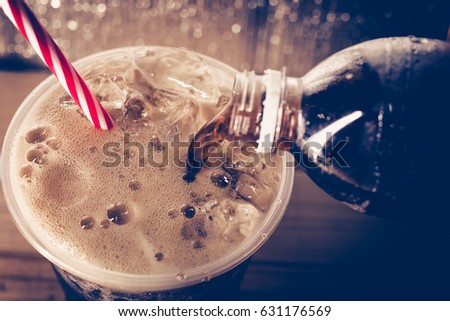 Refreshing Bubbly Soda Pop with Ice Cubes. Cold soda iced drink in a glasses - Selective focus, shallow DOF.