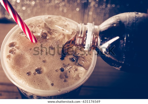 Refreshing Bubbly Soda Pop\
with Ice Cubes. Cold soda iced drink in a glasses - Selective\
focus, shallow DOF.