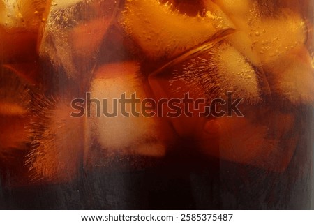 Refreshing coffee with ice cubes as background, closeup