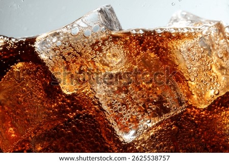 Refreshing cola with ice cubes against light grey background, closeup