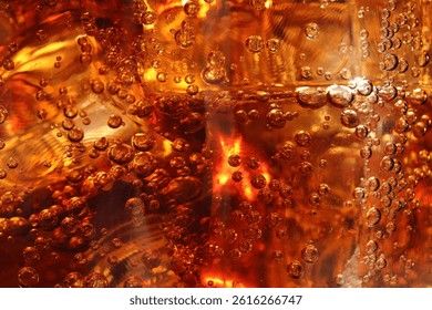 Refreshing cola with ice cubes as background, macro view