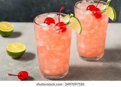 Refreshing Cold Cherry Limeade Soda with a Lime Garnish