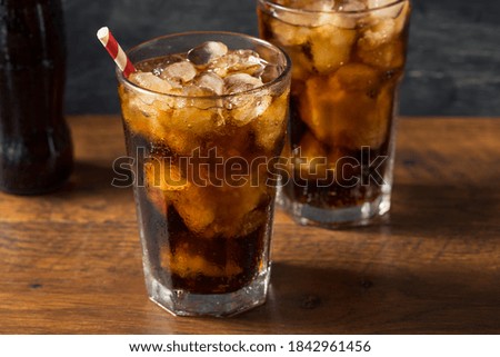 Refreshing Cold Dark Cola Soft Drink with a Straw