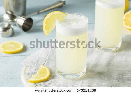 Refreshing Cold Egg Gin Fizz with a Lemon Garnish