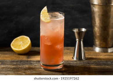 Refreshing Cold Sloe Gin Fizz Cocktail With A Lemon Garnish