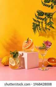 Refreshing Colorful Summer Drinks With Various Fruits: Pear, Grapefruit, Lemon On Yellow Background With Shadow Fern. Paloma Cocktails. Hard Seltzer Cocktails