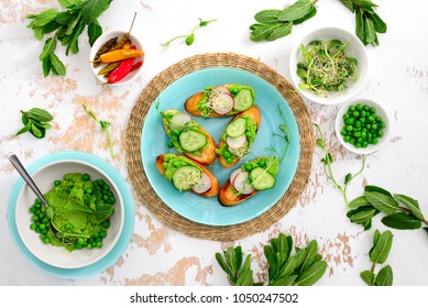 Refreshing Crusty Canapes With Green Peas And Mint Pesto, Radishes, Cucumbers And Sprouts Of Alfalfa, Overhead View