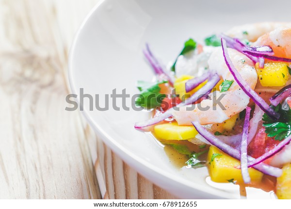 Refreshing dish of fish\
marinated in citrus juice. Shrimp and Mango Ceviche. Diet and\
healthy food concept