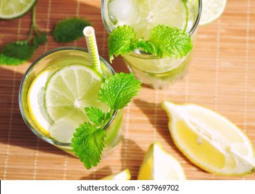 Refreshing Drink With Lemon Lime Mint And Ice And Ingredients - Summer Drinks Overhead, Top View