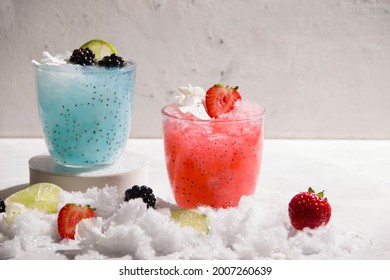 Refreshing Drinks Of Red And Blue Color With Ice And Berries On A White Background